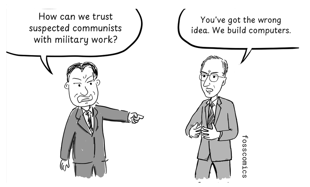 Senator Joseph McCarthy points accusingly at John Mauchly, who responds with open hands.